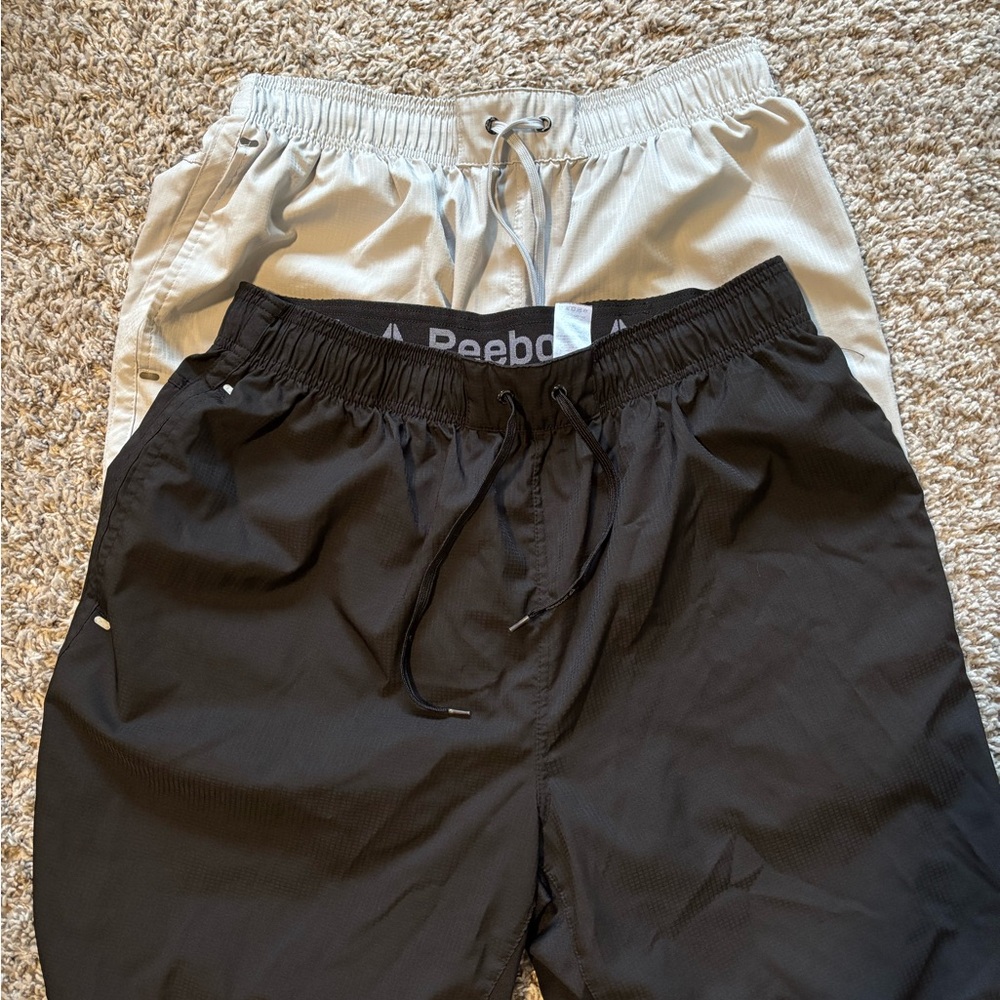 Two Pairs of Reebok Shorts, black and gray, sold as one unit
